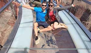 Sitting on glas on Grand Canyon Skywalk